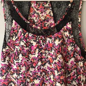 Satin tank blouse with black lace detail.